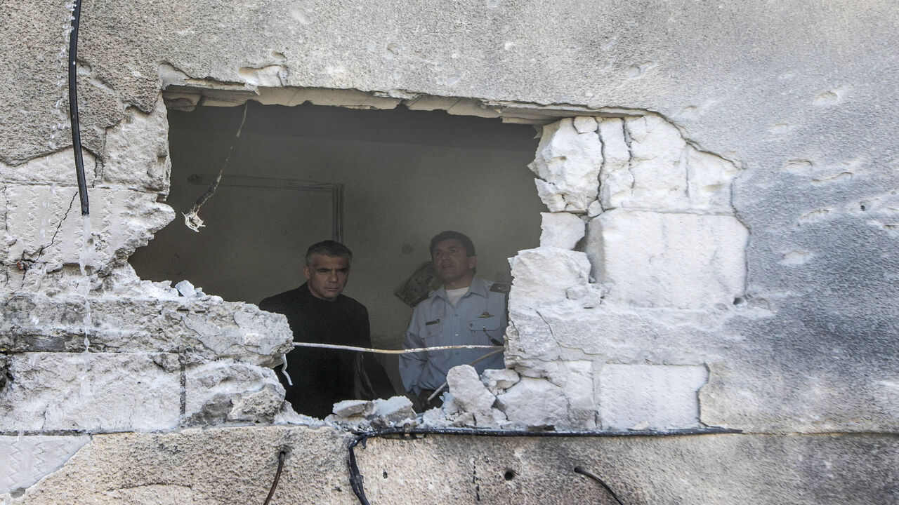 Israeli Finance Minister Yair Lapid (L) inspects the damage inside a house following a rocket attack by militants from the Gaza Strip on the southern town of Sderot, Israel, July 21, 2014.