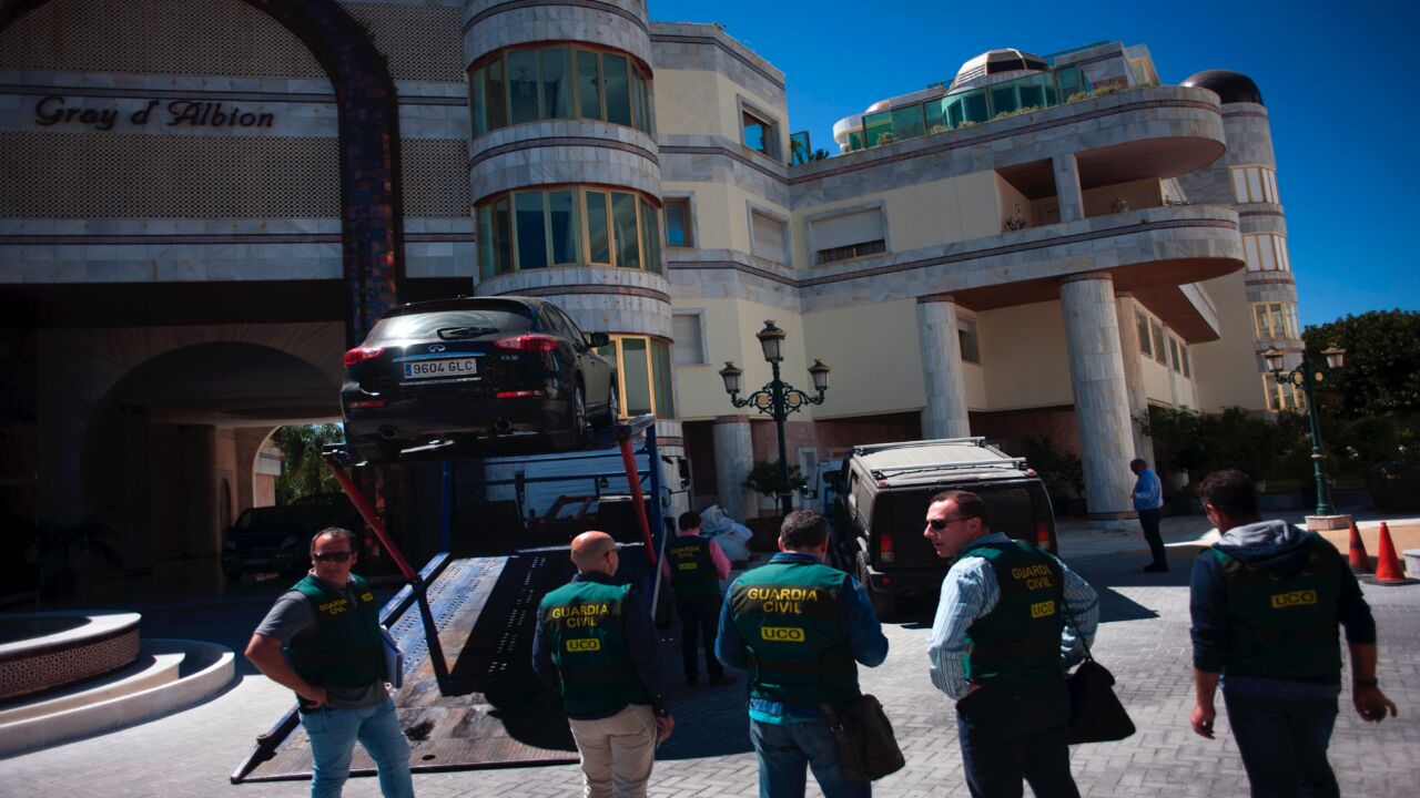 Members of the Spanish Guardia civil stand near vehicles seized during a raid targeting assets of the family of Syrian leader Bashar al-Assad in the Puerto Banus marina area of the plush resort of Marbella on April 4, 2017. 
