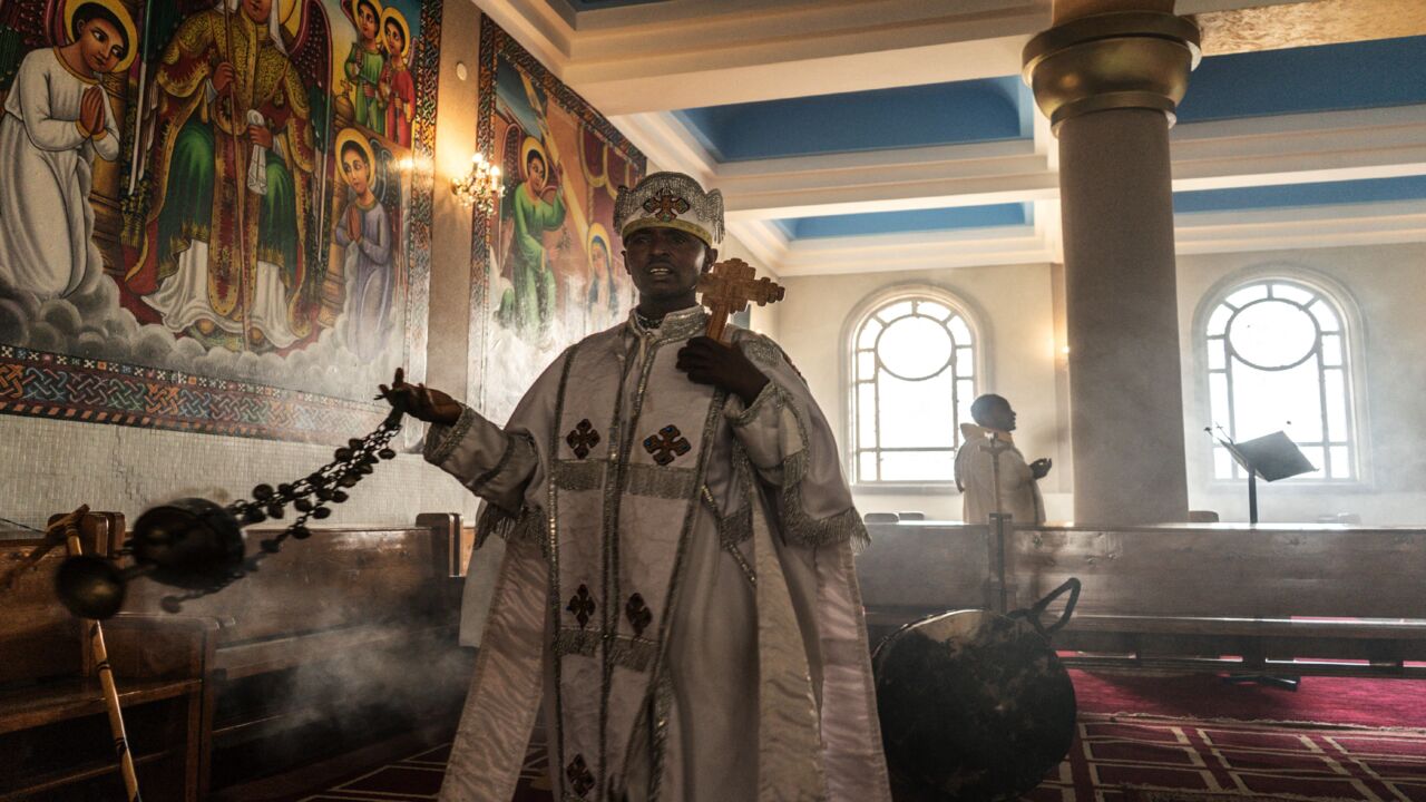 An Ethiopian Orthodox priest wafts incense during a prayer inside Bole Medhanialem church in Addis Ababa, Ethiopia, on June 20, 2021.