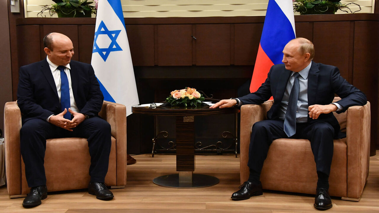 Russian President Vladimir Putin (R) speaks with Israeli Prime Minister Naftali Bennett during their meeting, in Sochi, Russia, Oct. 22 2021.