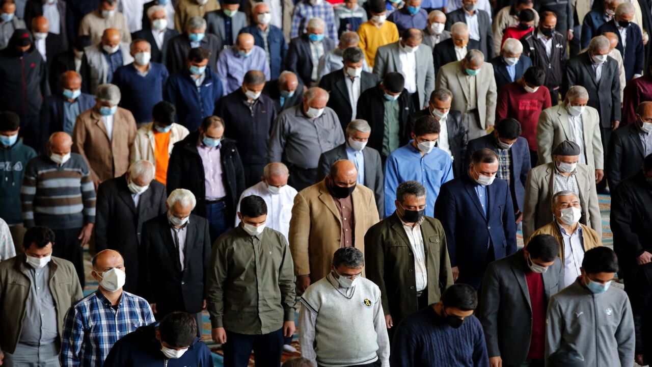 Mask-clad Iranians gather in a mosque in the capital, Tehran, to perform Friday prayers.