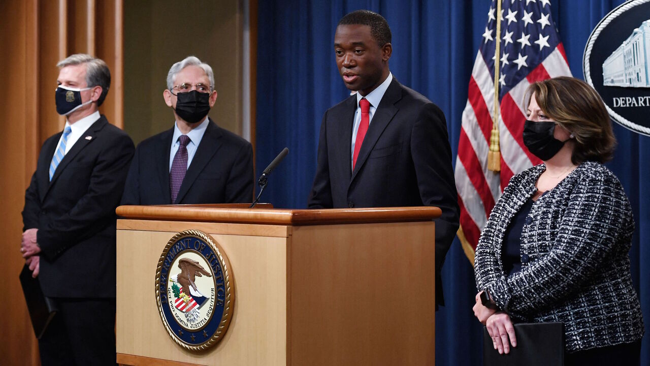 Deputy Secretary of the Treasury Wally Adeyemo speaks, alongside Attorney General Merrick Garland (2L), FBI Director Christopher Wray (L) and Deputy Attorney General Lisa Monaco (R) during a news conference over ransomware cyberattacks, at the Department of Justice, in Washington, DC on Nov. 8, 2021.  