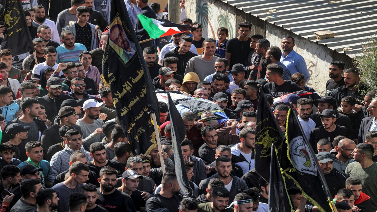 Palestinian mourners carry away the body of Saddam Bani Odeh, who was killed earlier amidst dawn clashes with Israeli troops.