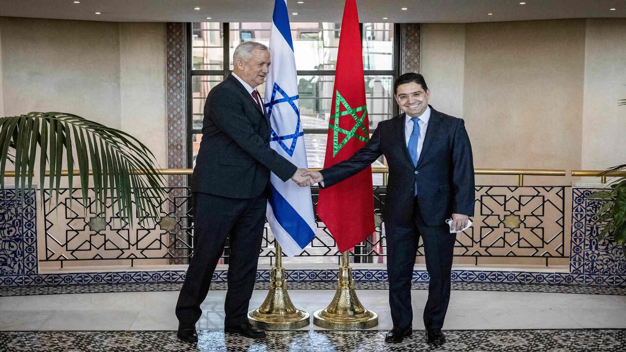 Morocco's Foreign Minister Nasser Bourita (R) shakes hands with Israel's Defence Minister Benny Gantz, Rabat, Morocco, Nov. 24, 2021.