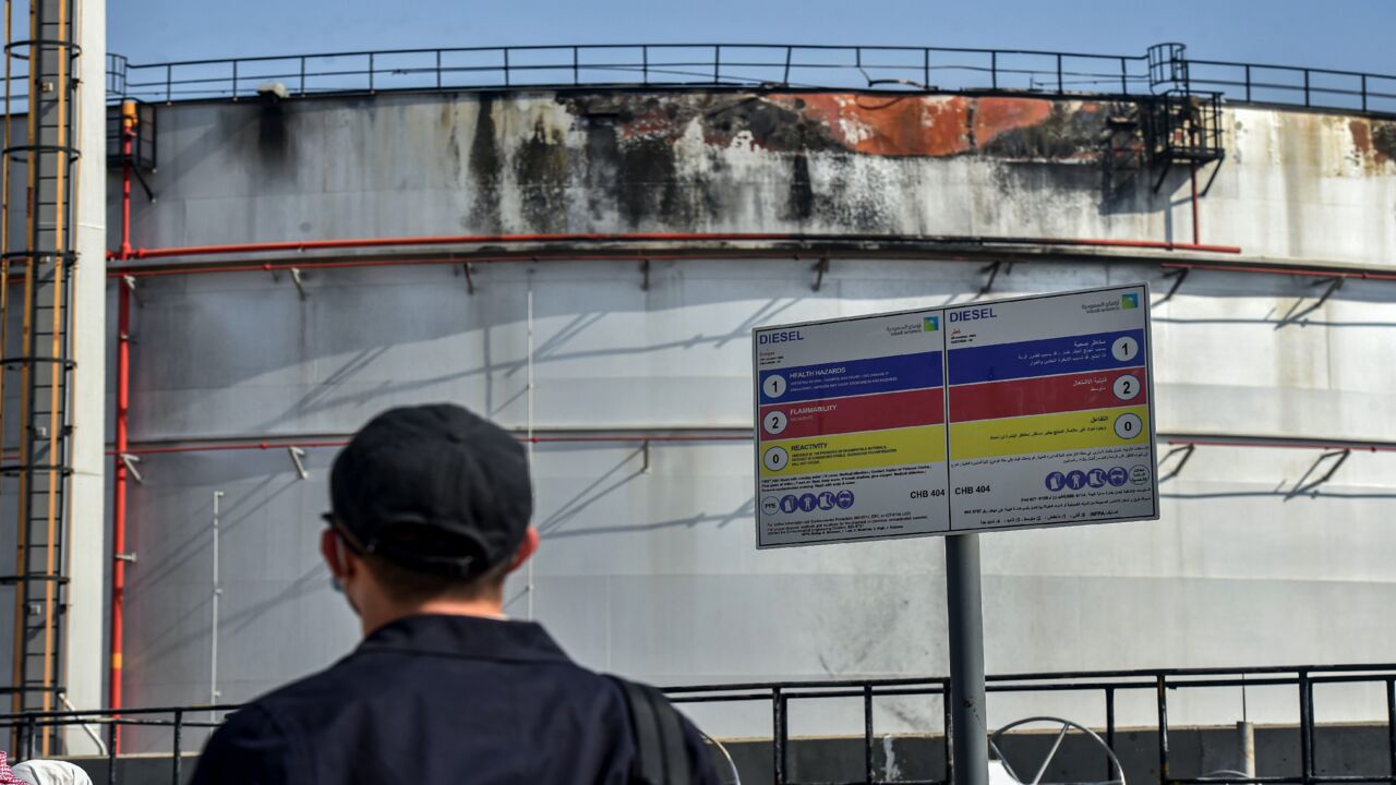 A man looks at a damaged silo a day after an attack at the Saudi Aramco oil facility in Saudi Arabia's Red Sea city of Jeddah, on Nov. 24, 2020. 