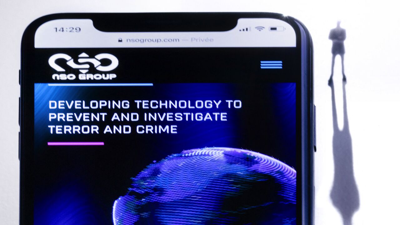 This studio illustration shows a smartphone with the website of Israel's NSO Group, which features Pegasus spyware, July 21, 2021.