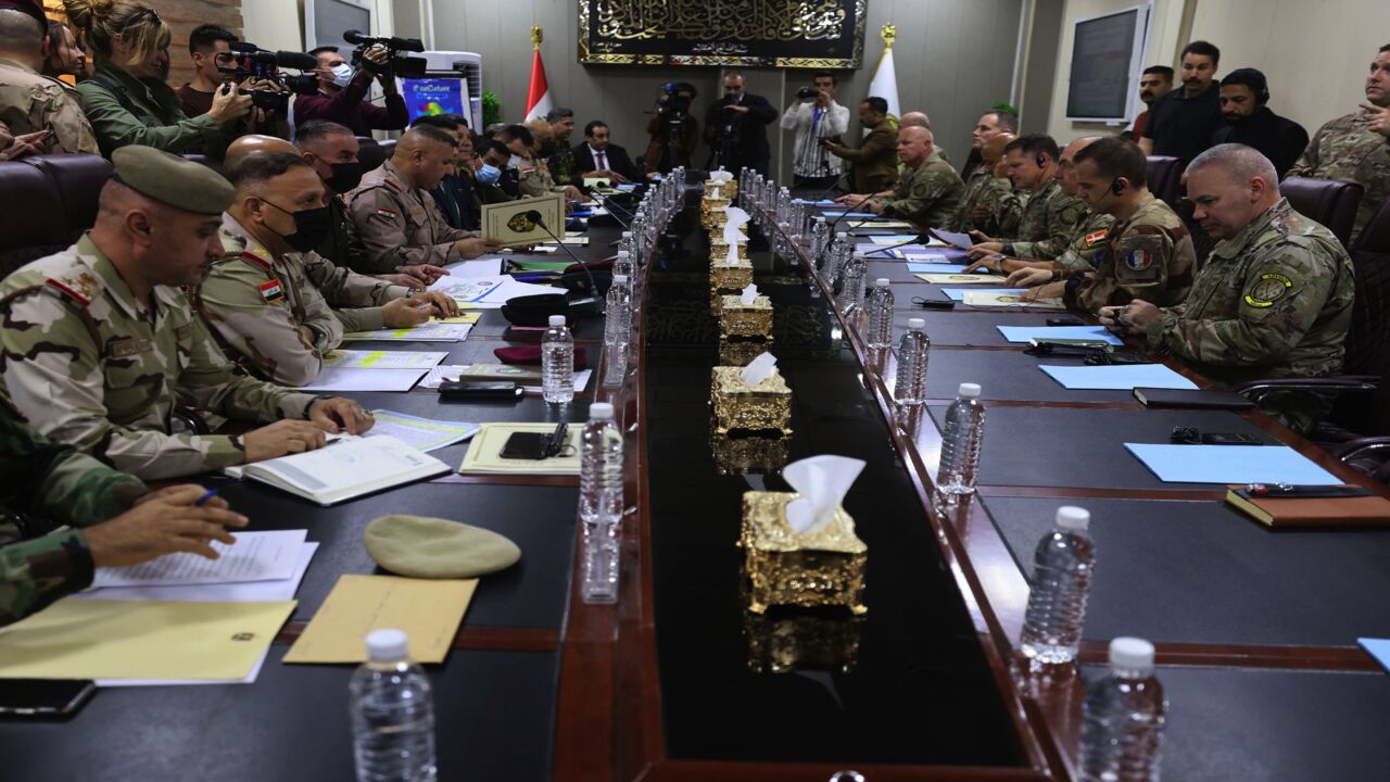 Commanding officers of the US-led international coalition against the Islamic State (R) and senior Iraqi commanders (L) meet at the Joint Operations Center in Baghdad's Green Zone, Dec. 9, 2021. 