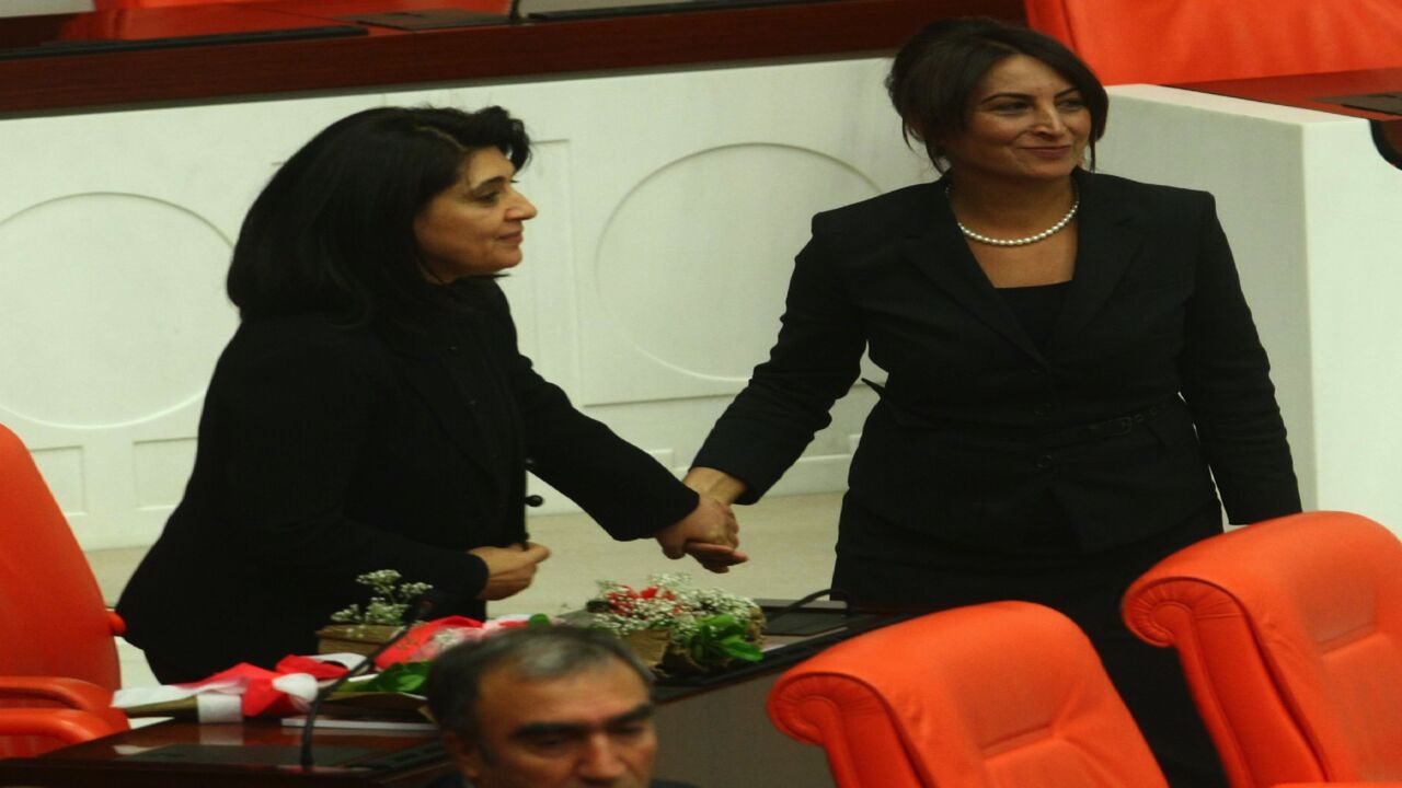 Pro-Kurdish lawmaker Leyla Zana is embraced by lawmaker Aysel Tugluk (R) as she arrives at the parliament in Ankara on Oct. 1, 2011. 