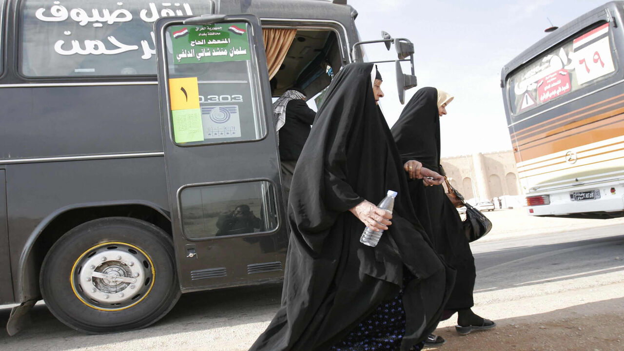 Iraqi women ready to board a coach, part of a convoy, heading south of the Iraqi city of Karbala some 120 kilometers (74 miles) from the capital Baghdad, toward the Saudi Arabian city of Mecca, Nov. 22, 2008.