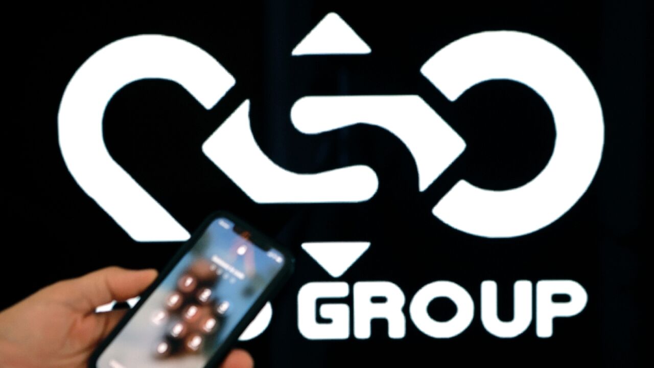 (FILES) In this file photo taken on February 09, 2022, a photographic illustration shows a mobile phone near the NSO Group company logo in the Israeli city of Netanya. 