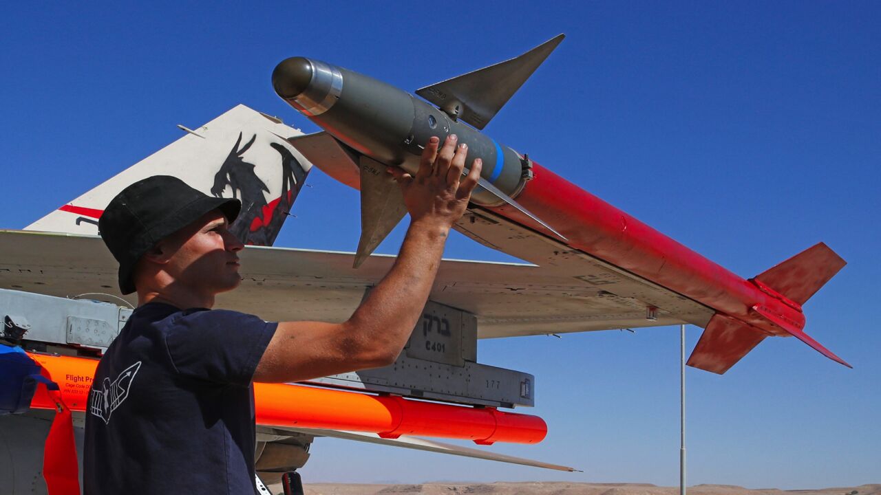 An Israeli air force mechanic inspects an F-16 fighter at Ovda air force base north of the Israeli city of Eilat, on Oct. 24, 2021.