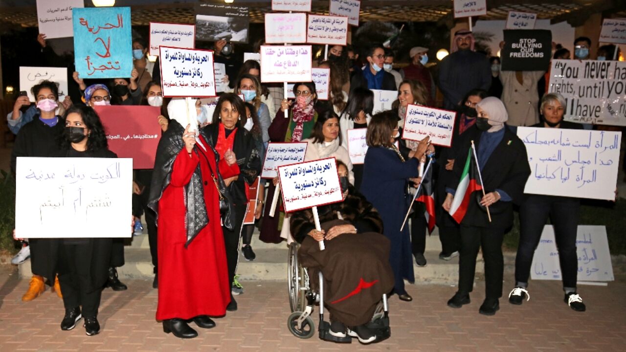 Women activists rally in support of their right to exercise activities, outside the National Assembly in Kuwait City, after a women's yoga retreat denounced as "indecent" was postponed