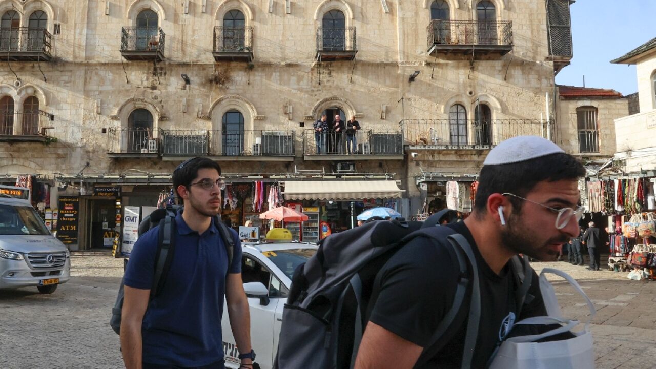 Israeli settlers walk past the Petra Hotel at the Jaffa gate area in Jerusalem's old city -- Greek Orthodox leaders denounced what the Church called the "illegal" takeover of the hotel by Israeli "extremists"