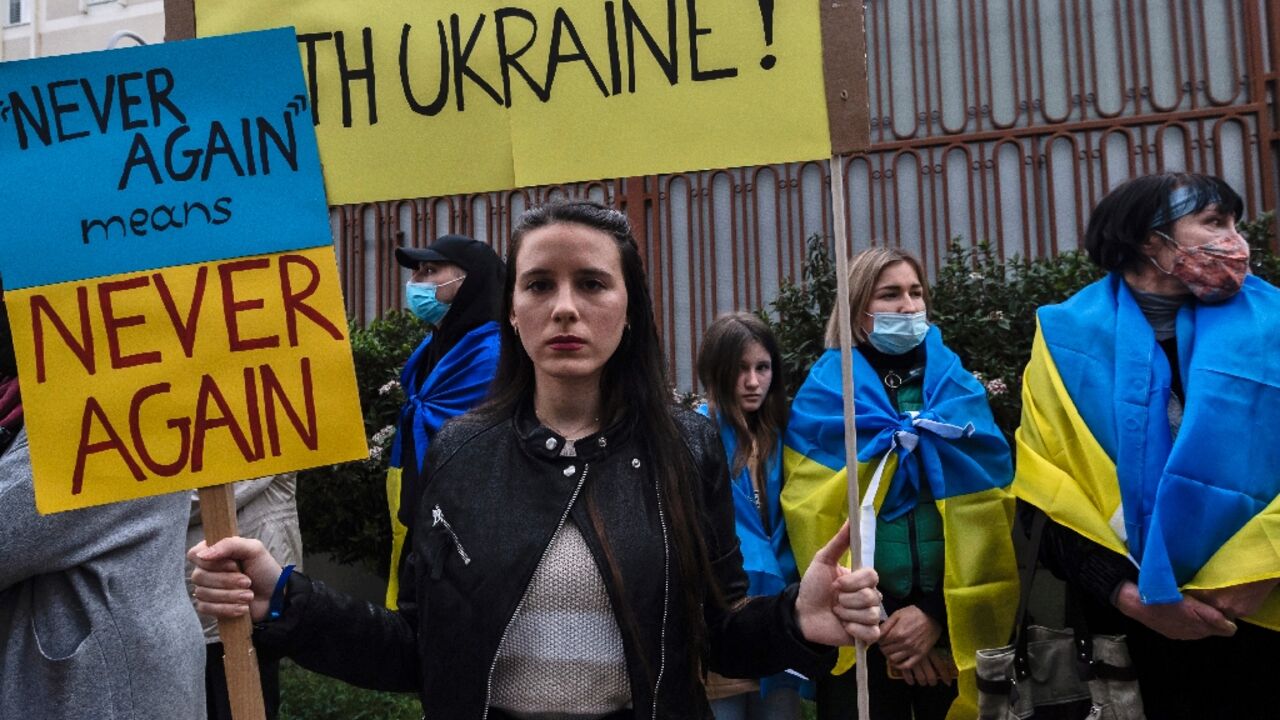 Ukrainians and Cypriots take part in a protest outside the Russian embassy in Nicosia on Tuesday; President Nicos Anastasiades has said the island stands "together with all Europeans"