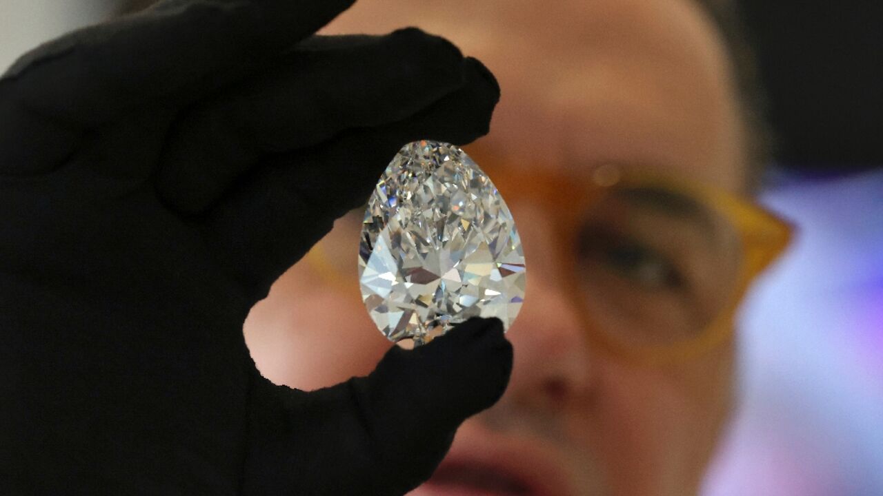 A Christie's auction house staff member displays the giant diamond nicknamed "The Rock" in Dubai