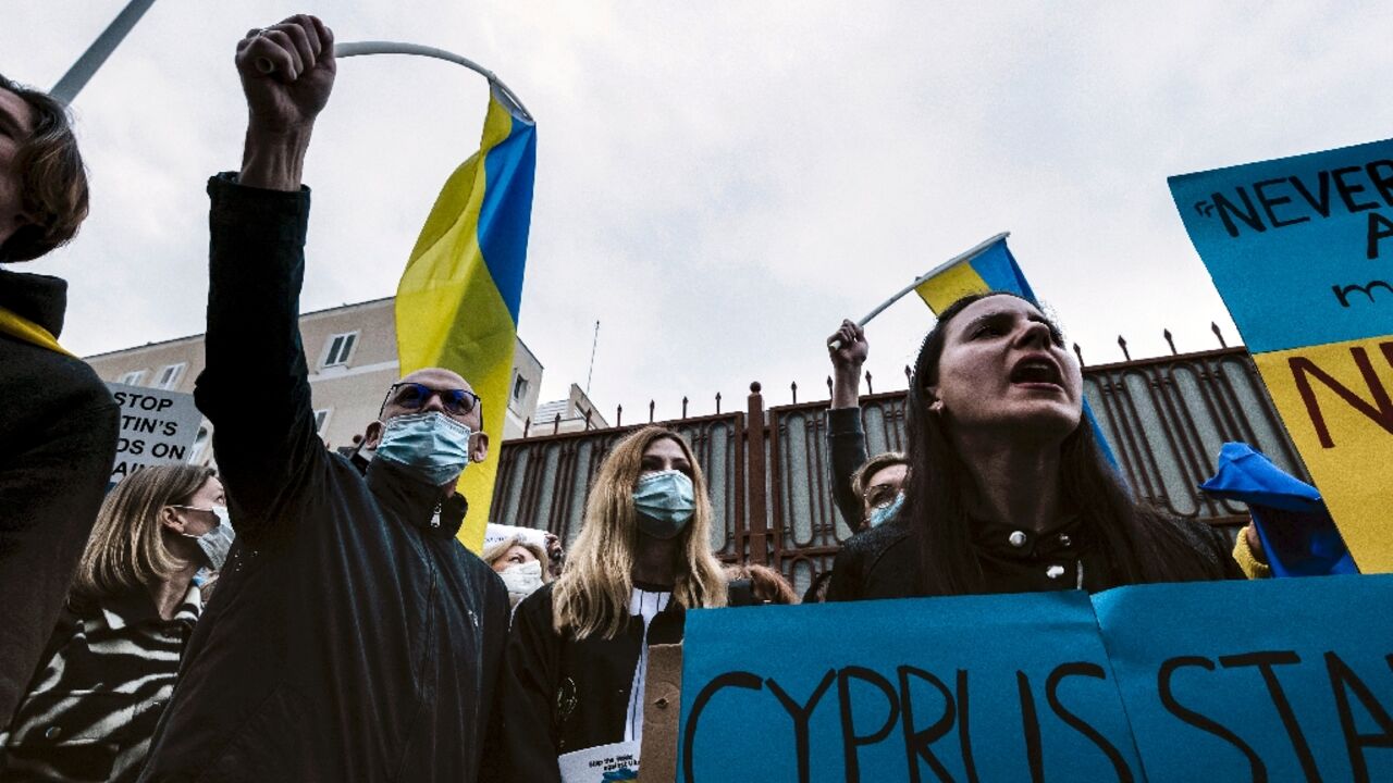 Ukrainians and Cypriots protest outside the Russian embassy in the Cypriot capital Nicosia on Tuesday against the military invasion of Ukraine