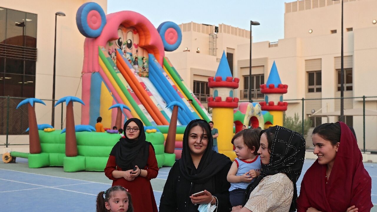 Afghan refugees gather in a playground at the Park View Villas in Qatar's capital Doha 