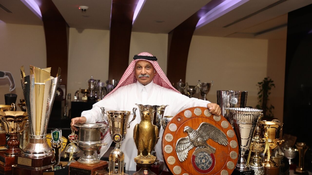 Hassan Mattar a former Al-Sadd striker who now works for the club, poses  with its trophies - before the team clinched its latest league title