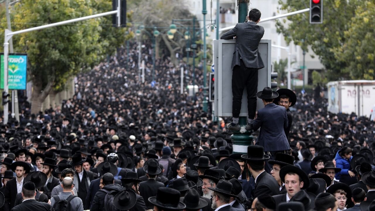 Ultra-Orthodox Jewish men walk in the funeral procession of rabbi Chaim Kanievsky in the Israeli city of Bnei Brak near Tel Aviv