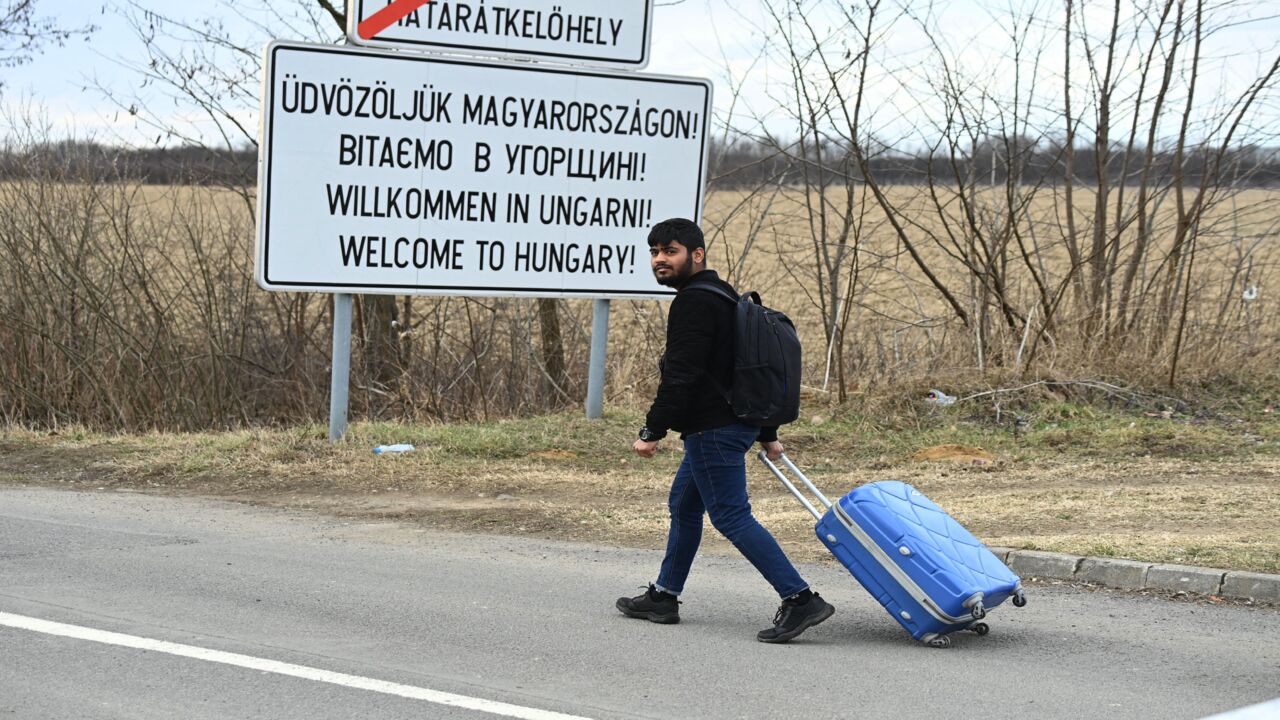 A university student crosses the border from Ukraine by foot in Barabas, Hungary, on Feb. 28, 2022.