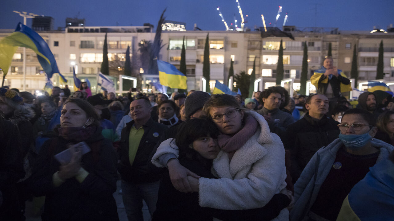 Demonstrators gather to watch Ukrainian President Volodymyr Zelenskyy's speech to the Knesset during a live broadcast at Habima Square, Tel Aviv, Israel, March 20, 2022.