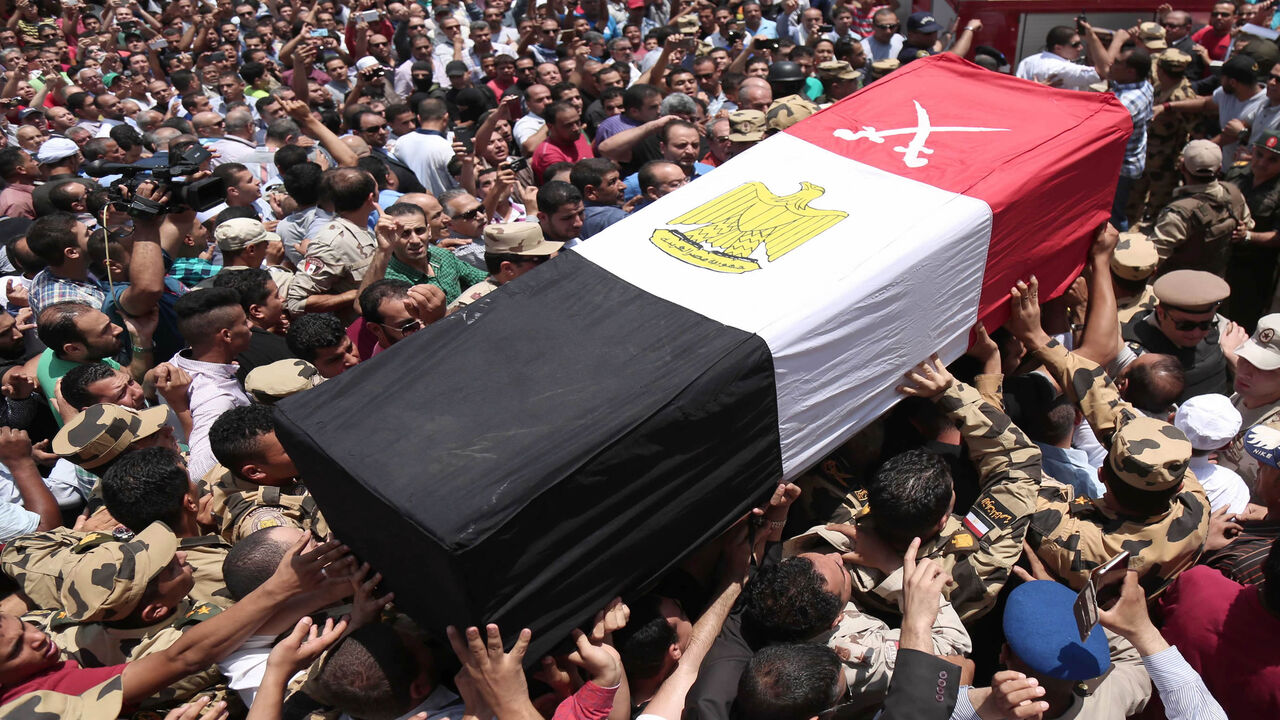 Egyptians carry the coffin of a soldier who was killed a day earlier in the restive Sinai Peninsula in an attack claimed by the Islamic State, during a funeral ceremony in the 10th of Ramadan city, north of Cairo, Egypt, July 8, 2017.