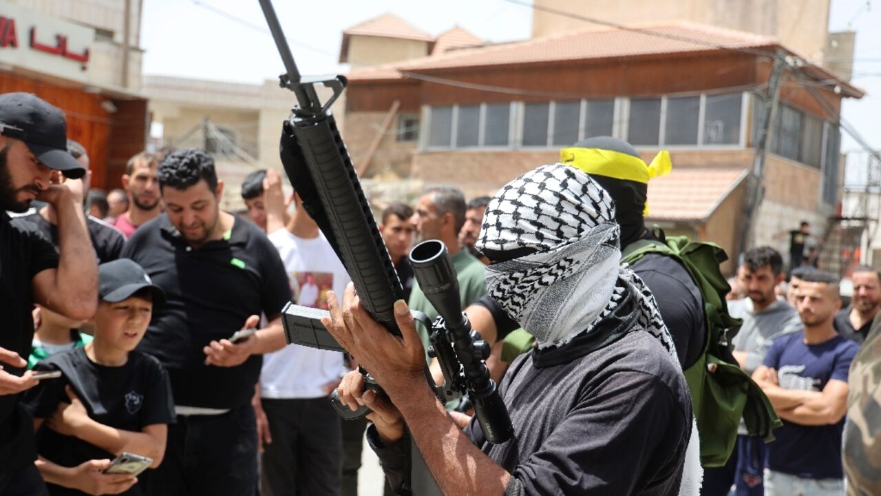 Members of the Palestinian Al-Aqsa Martyr's Brigades faction affiliated with the Fatah movement take part in the funeral of Yahya Adwan in his village of Azzun in the north of the occupied West Bank