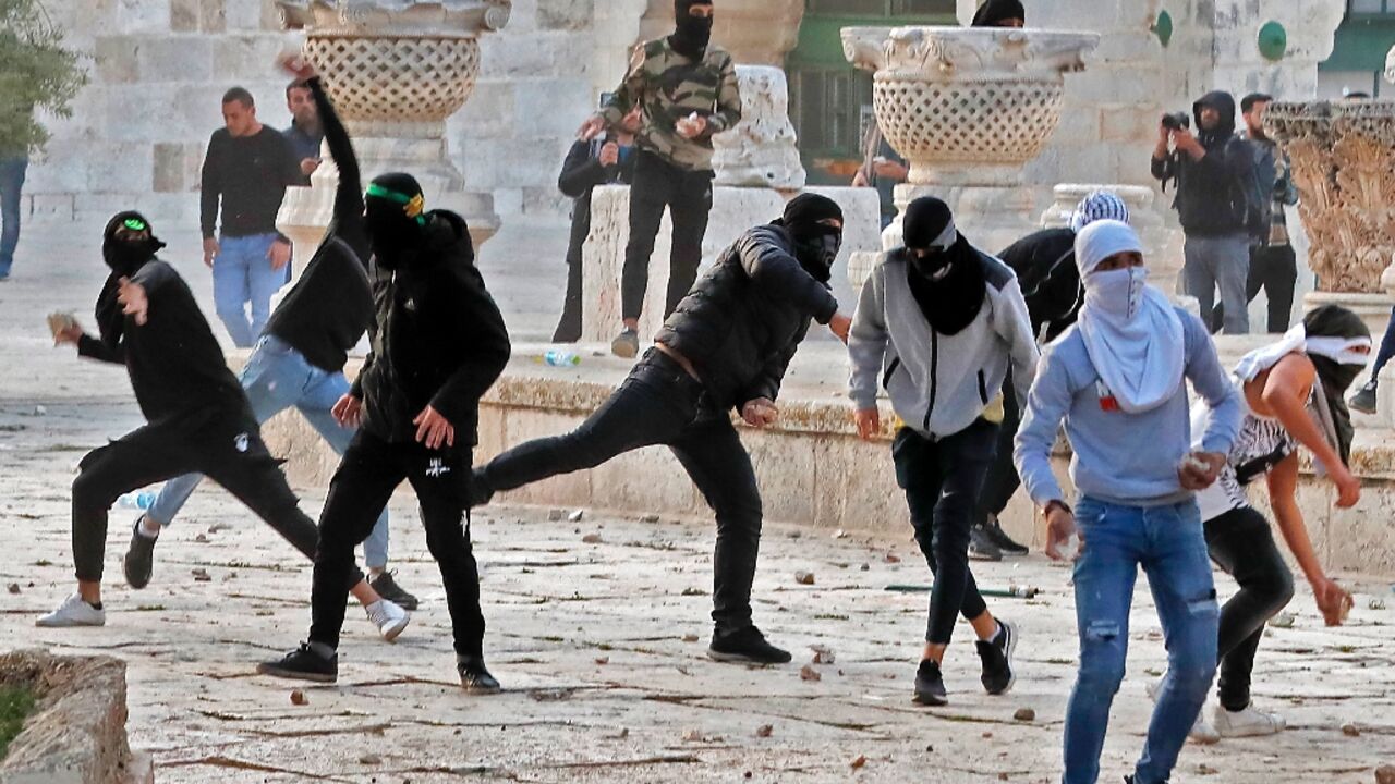 Palestinian demonstrators clash with Israeli police at Jerusalem's Al-Aqsa mosque compound after the morning prayers in east Jerusalem