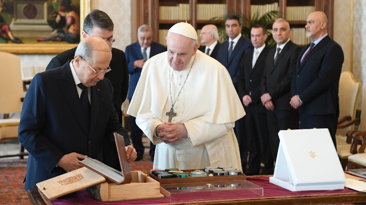 Pope Francis exchanges gifts with Lebanon's President Michel Aoun at the Vatican on March 21, 2022
