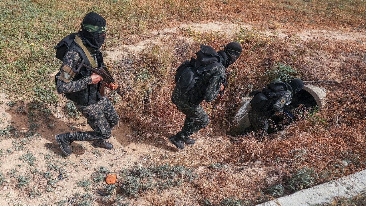 The Gaza Strip is run by Hamas, but it is also home to the Islamic Jihad militant group, whose personnel are pictured entering a tunnel in the Palestinian enclave on Sunday