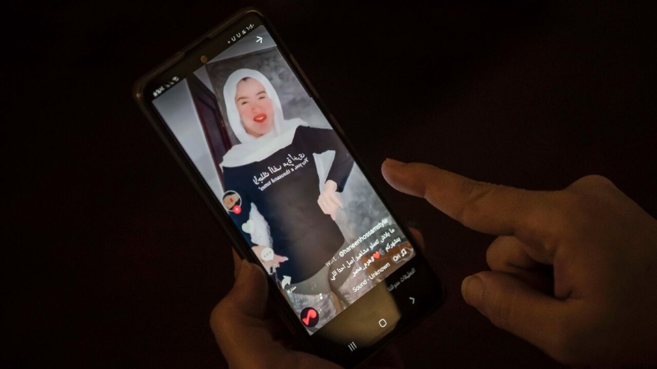 A woman watches a video of Egyptian influencer Haneen Hossam on the video-sharing app TikTok in Egypt's capital Cairo on July 28, 2020