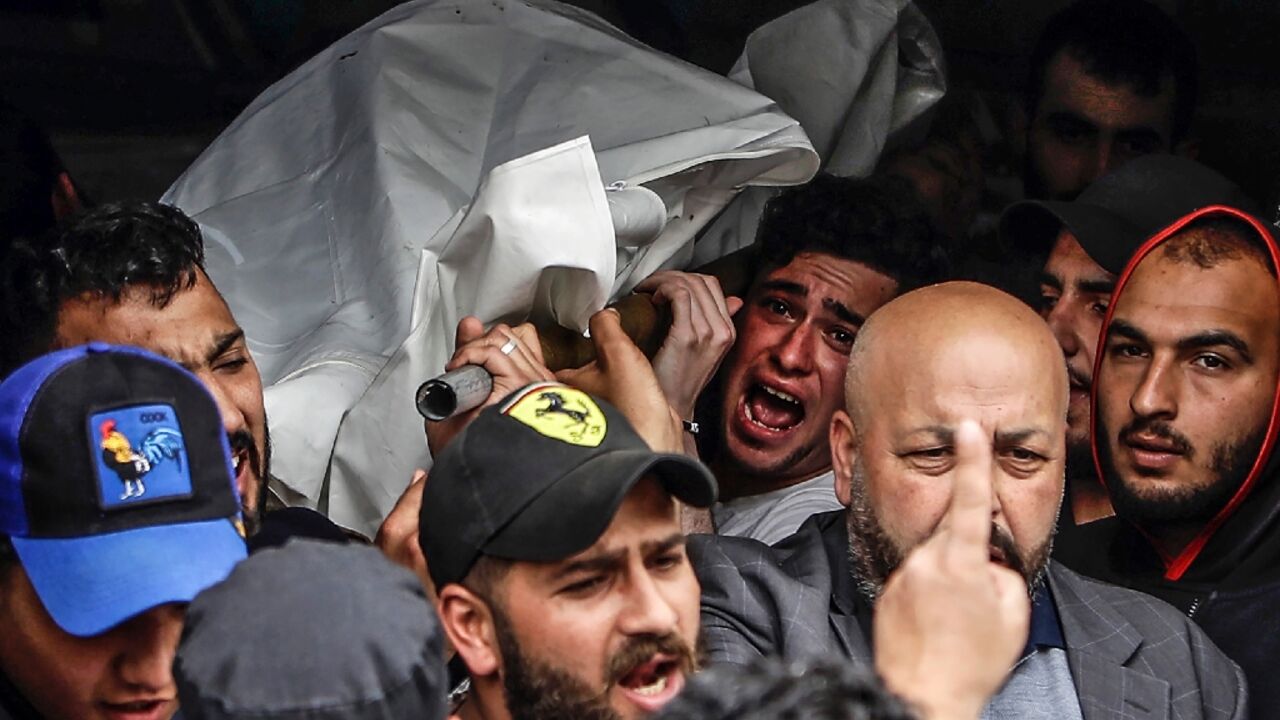 Mourners carry the corpse of one of the people who died when their boat capsized off Tripoli in northern Lebanon 