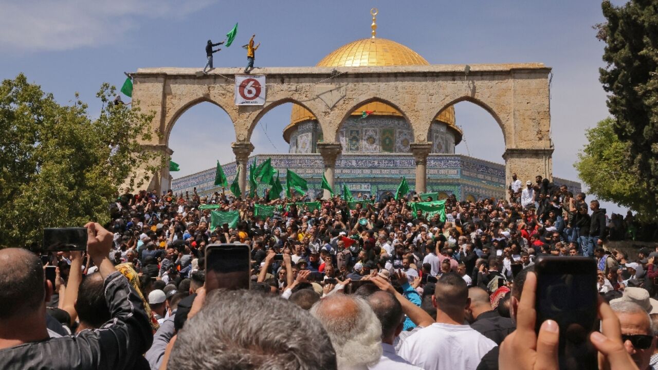 Palestinian gather to protest after Friday prayers, the third of the Muslim holy month of Ramadan, at Jerusalem's Al-Aqsa mosque compound, on April 22, 2022