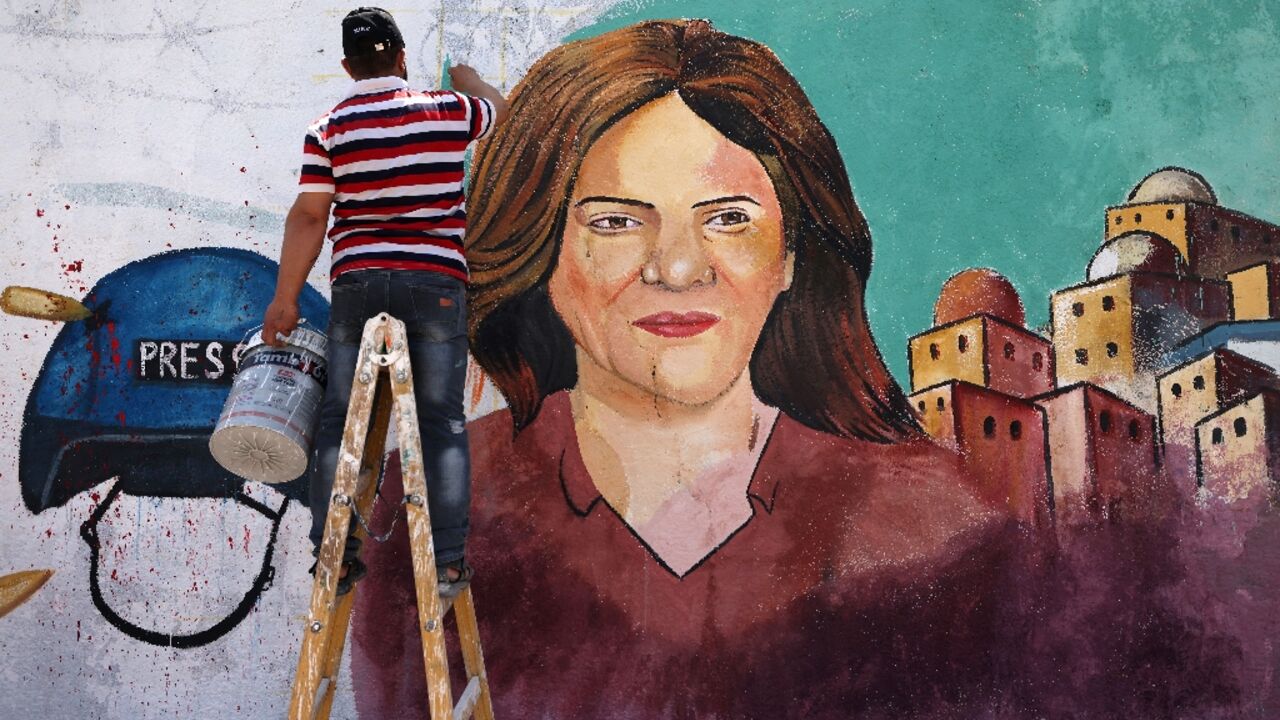 Palestinian artists paint a mural in honour of slain veteran Al Jazeera journalist Shireen Abu Akleh in Gaza City on May 12