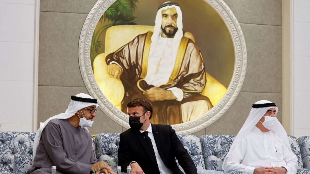 French President Emmanuel Macron, at the centre, meets the newly-elected president of the United Arab Emirates, Sheikh Mohammed bin Zayed Al Nahyan, on the left, at Al Mushrif Palace in Abu Dhabi on May 15, 2022