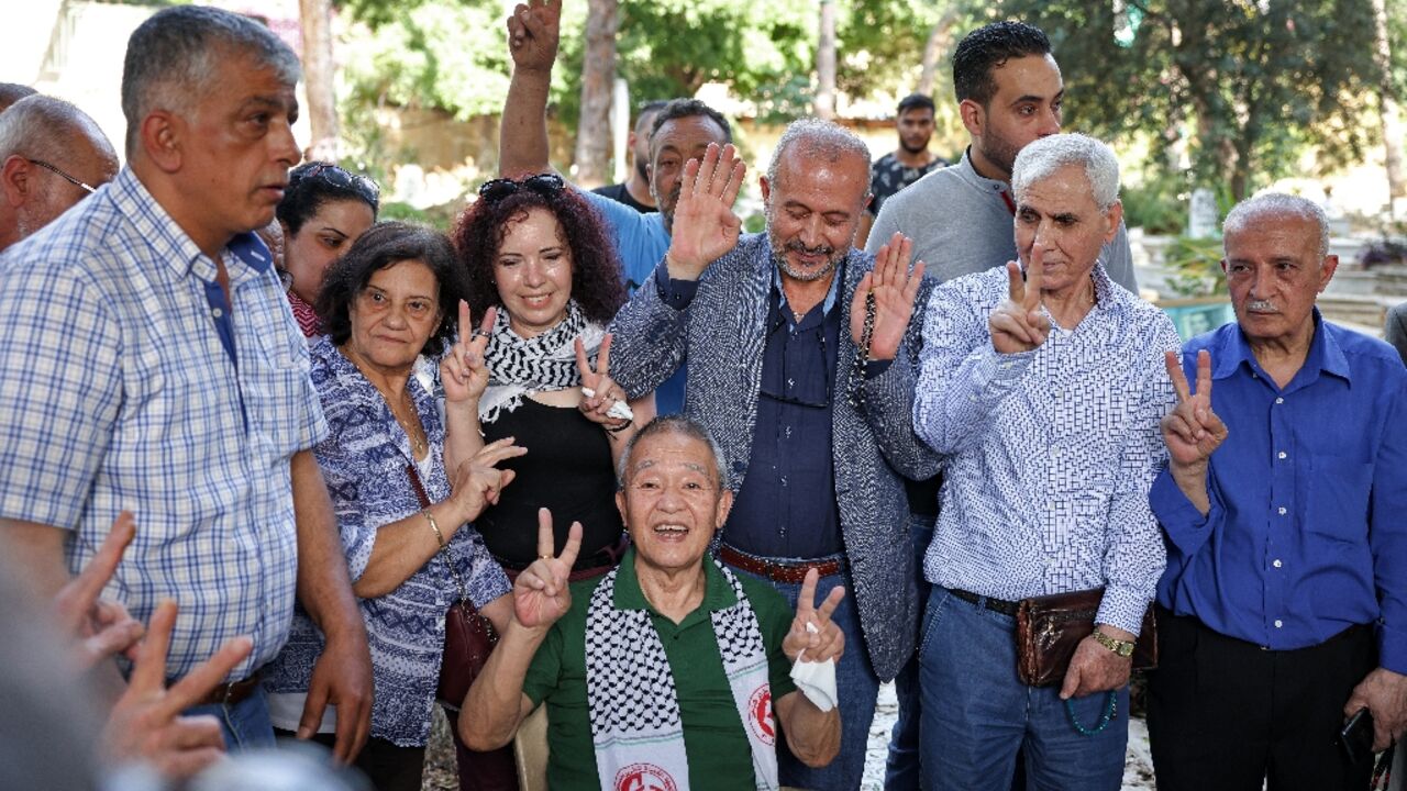 Kozo Okamoto (C), the only surviving member of a three-man Japanese Red Army commando that killed 26 people at Israel's Lod airport on May 30, 1972, gestures at a ceremony organised by Palestinian militants in Beirut