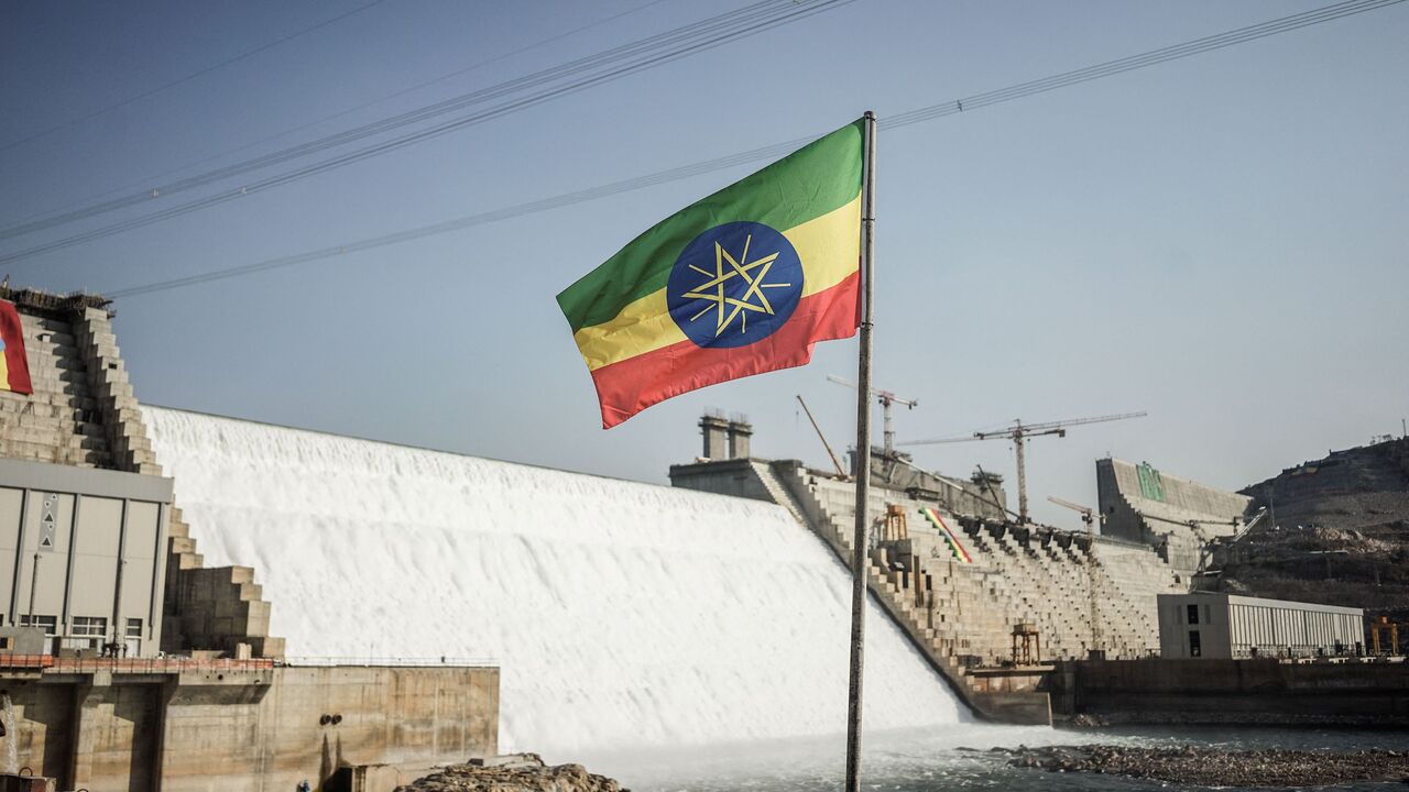 This general view shows an Ethiopian national flag flying infront of the Grand Ethiopian Renaissance Dam (GERD) in Guba, Ethiopia, on Feb. 19, 2022. 