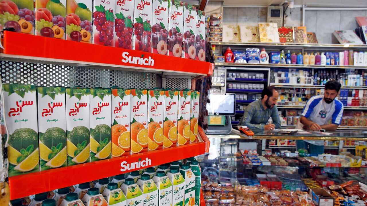 Iranians work at a food store in Tehran on May 13, 2021.