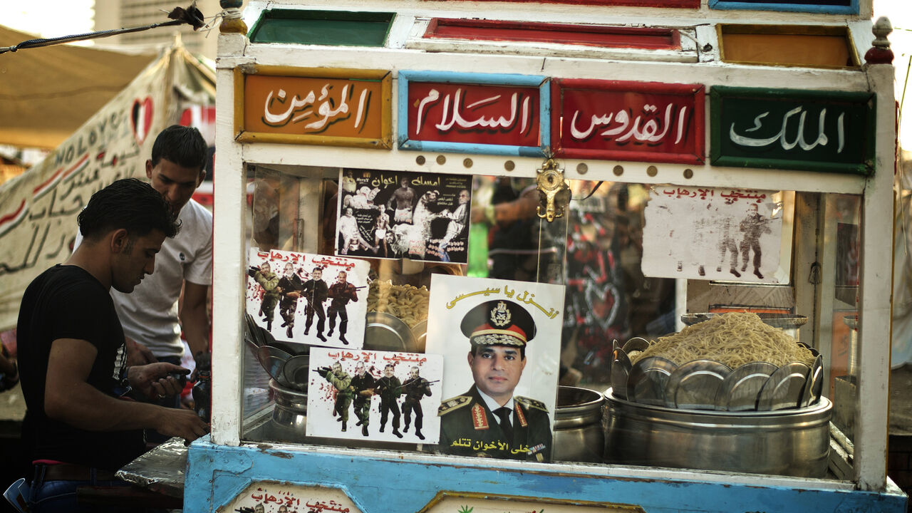 The portrait of Egyptian Defense Minister Abdel Fattah el-Sisi is seen on a street vendors cart in Egypt's landmark Tahrir Square on July 4, 2013.