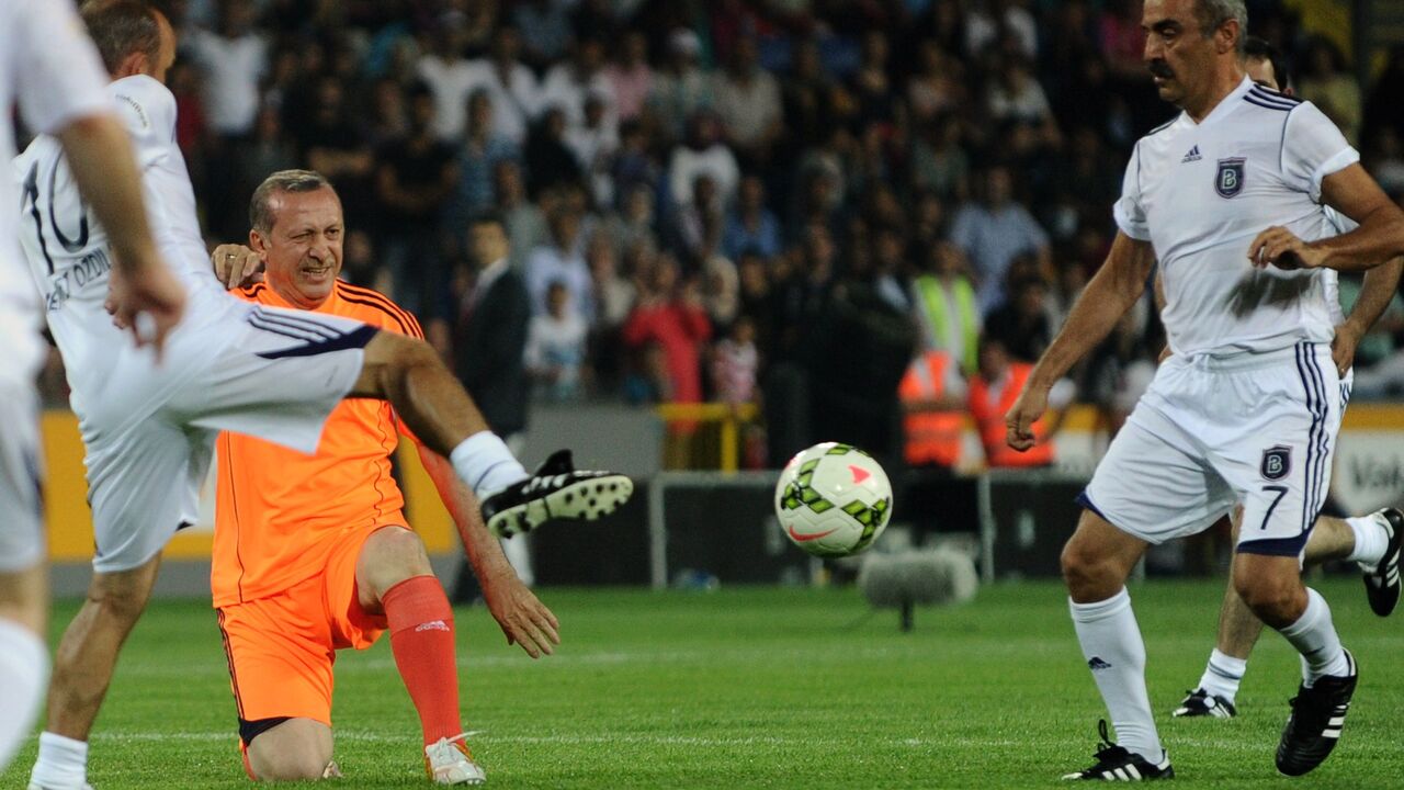 Turkish Prime Minister Recep Tayyip Erdogan (L) takes part in an exhibition football match.