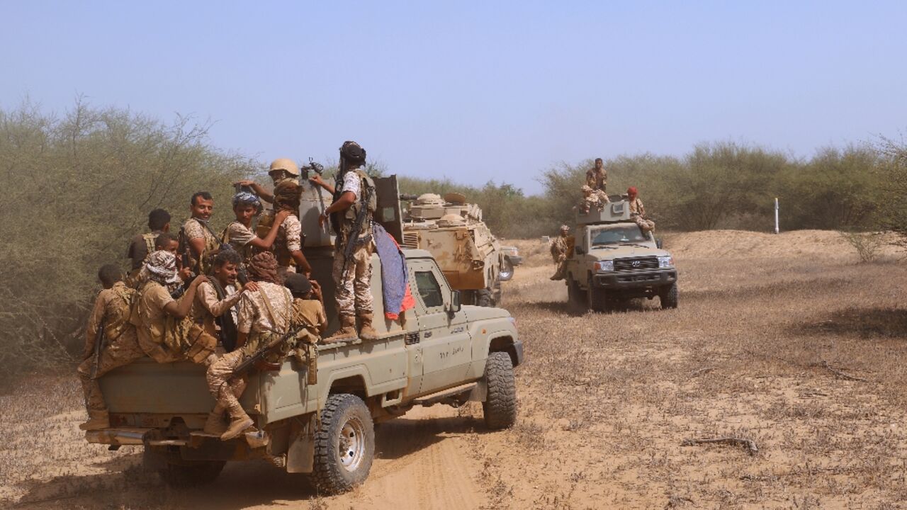In this file photo taken on February 4, 2022, Yemeni pro-government fighters man a position near Al-Muhsam camp during fighting to drive  the pro-Iran Huthi rebels from the area of Harad, in Yemen's Hajjah province