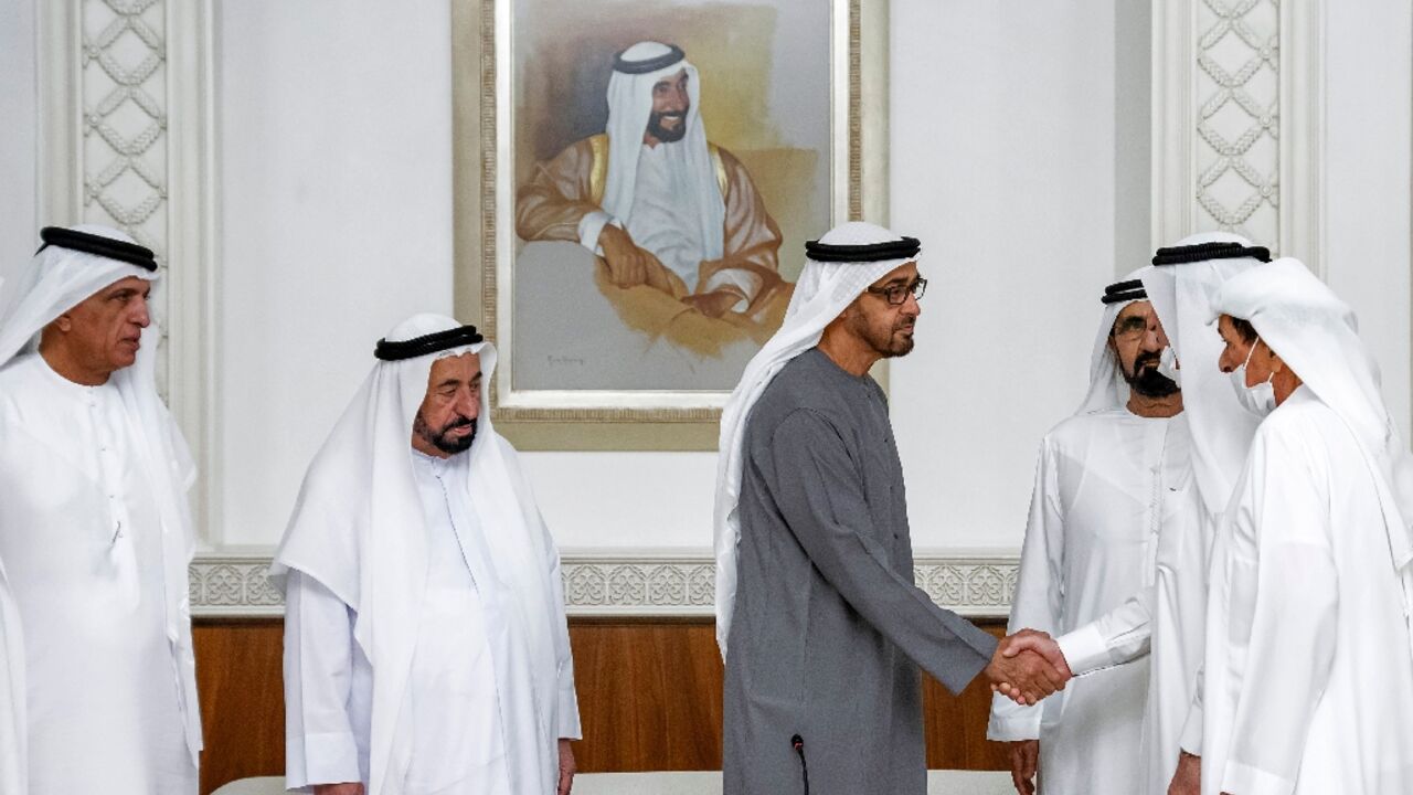 Sheikh Mohamed bin Zayed Al Nahyan (C) is congratulated with a handshake from Sheikh Saud bin Rashid al-Mualla of Umm al-Quwain (2nd-R) after his election as UAE President by the UAE's Federal Supreme Council as other council members look on