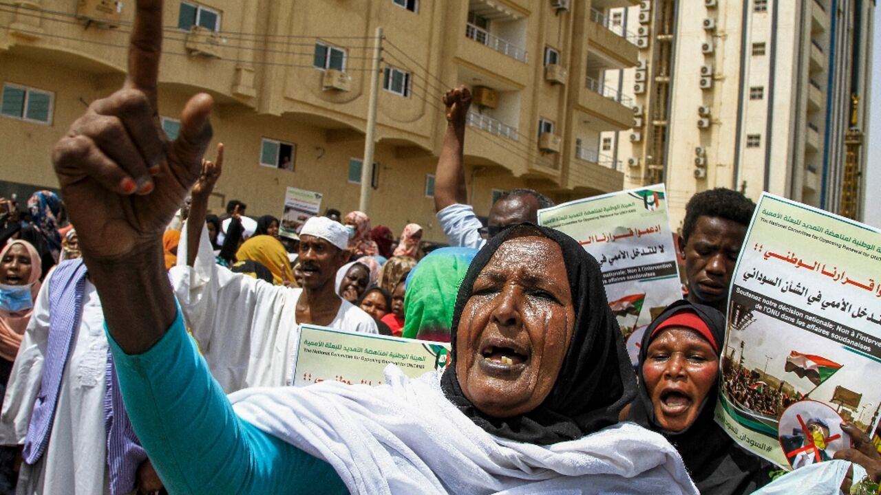 A Sudanese women protests outside the United Nations headquarters in Khartoum, calling for the UN chief in Sudan to quit