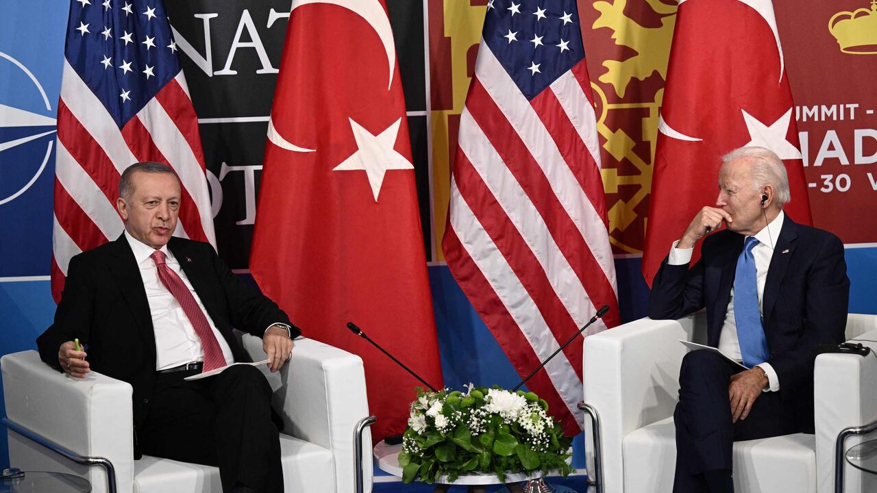 US President Joe Biden (R) listens as Turkey's President Recep Tayyip Erdogan.