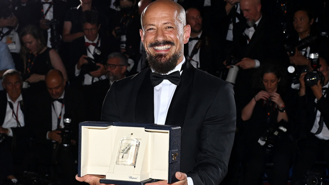 Director Tarik Saleh poses with the Best Screenplay Award for the movie "Walad Min Al Janna." 