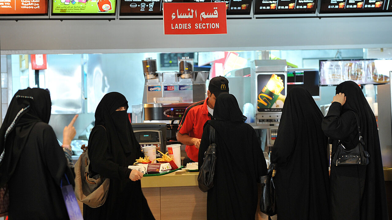 Saudi women wait in line in the "women's section" of a fast food restaurant in Faysalia mall, Riyadh City, Saudi Arabia, Sept. 26, 2011.