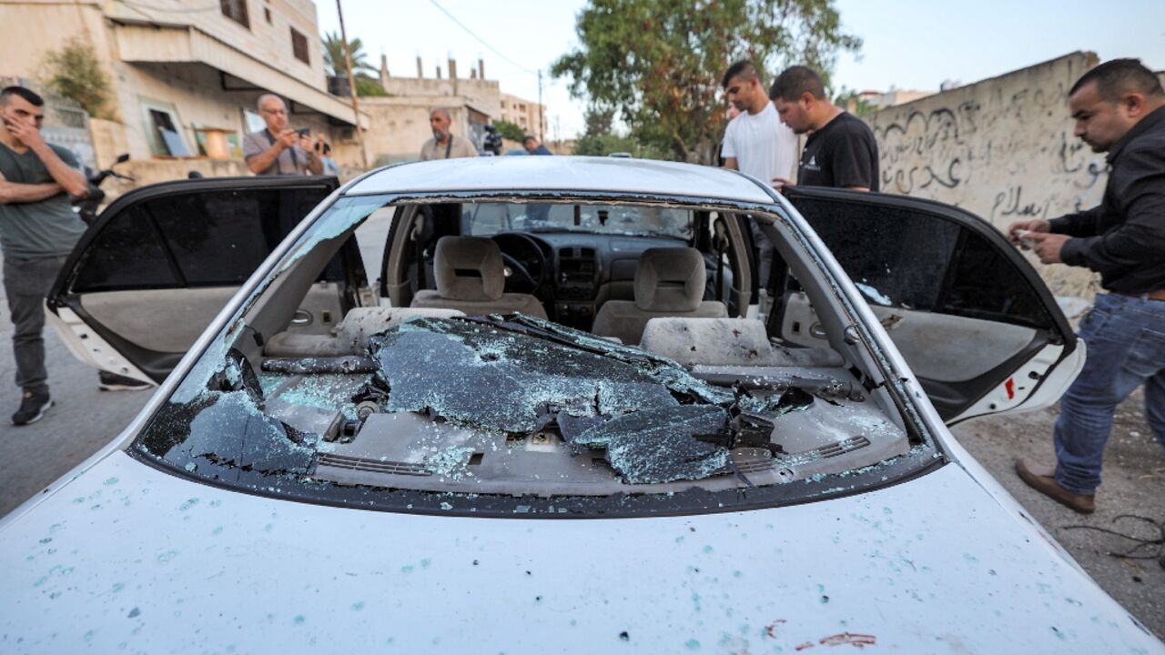 People inspect a bullet-riddled vehicle where three Palestinians were killed in an operation by Israeli forces in Jenin in the occupied West Bank