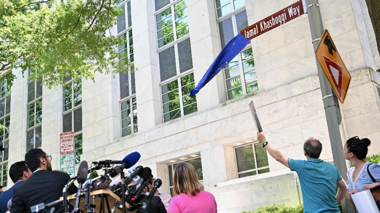 A street sign for Jamal Khashoggi Way is unveiled during outside the embassy of Saudi Arabia in Washington