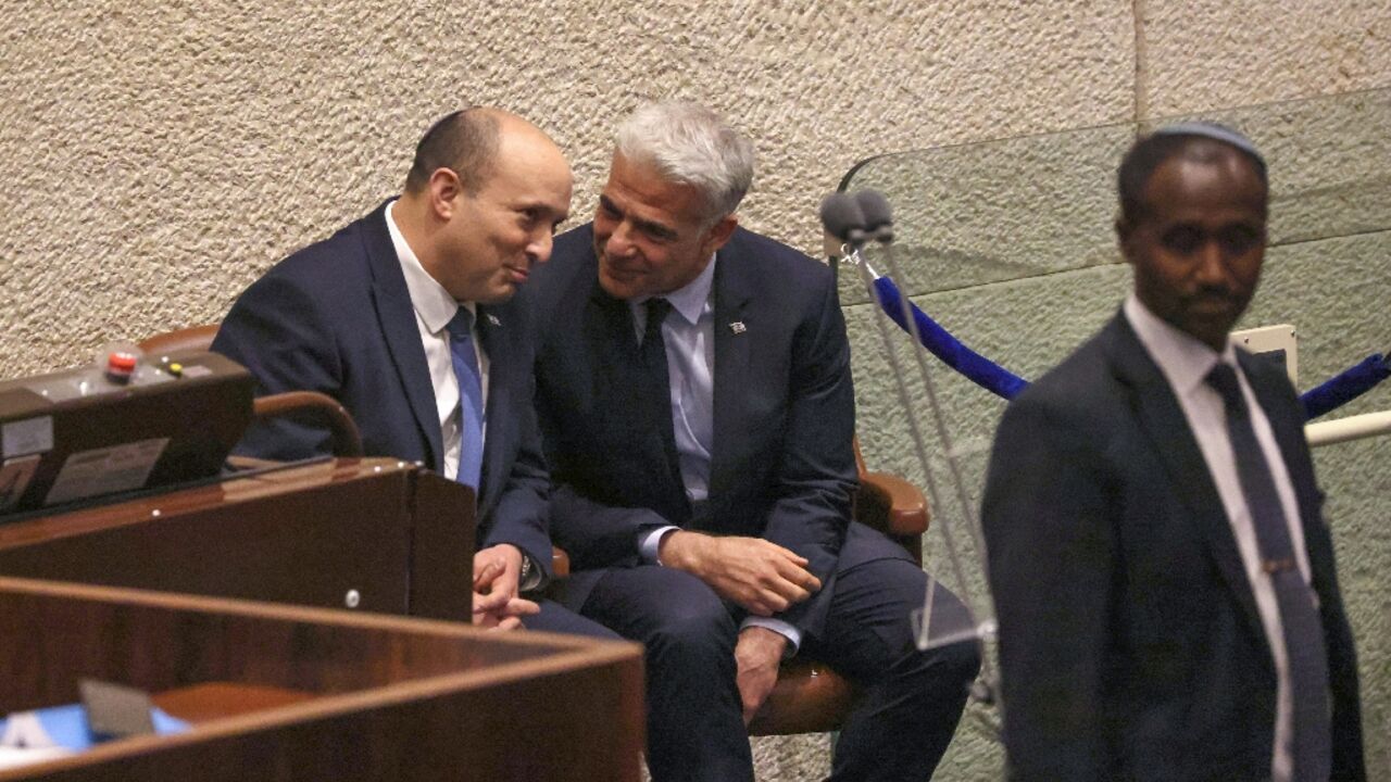 Israeli Prime Minister Nafatali Bennett and Foreign Minister Yair Lapid speak in parliament