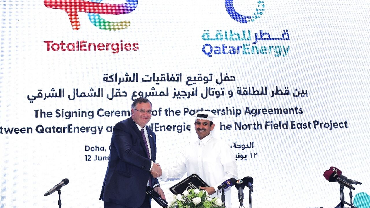 Qatar's Energy Minister and CEO of QatarEnergy Saad Sherida al-Kaabi (R) and French energy group TotalEnergies CEO Patrick Pouyanne attend a signing ceremony in Doha 